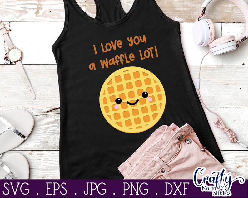 May include: Black tank top with the text "I Love you a Waffle LOT!" in white. A yellow waffle with a smiling face is in the center of the tank top.