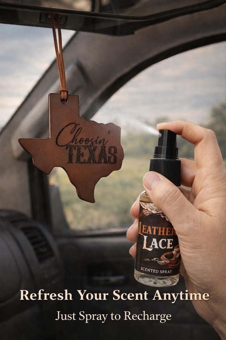 May include: A brown leather air freshener shaped like the state of Texas with the text Choosin' TEXAS, hanging from a brown cord. A clear spray bottle with a black nozzle and a label reading LEATHER LACE SCENTED SPRAY is being used to mist it.
