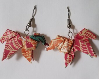 May include: A pair of origami elephant earrings with a colorful patterned paper design. The earrings are made with silver hooks.