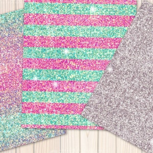 May include: Three sheets of glitter paper with different patterns. One sheet is a gradient of pink, blue, and purple. Another sheet has pink and turquoise stripes. The third sheet is a solid silver colour.