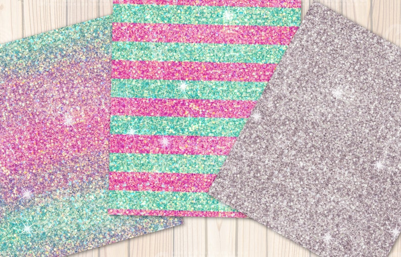 May include: Three sheets of glitter paper with different patterns. One sheet is a gradient of pink, blue, and purple. Another sheet has pink and turquoise stripes. The third sheet is a solid silver colour.