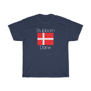 May include: A navy blue t-shirt with the text "Stubborn Dane" and a red and white Danish flag graphic.