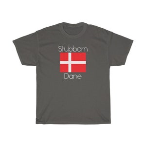 May include: A dark gray t-shirt with the text "Stubborn Dane" and a red and white Danish flag.
