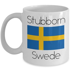 May include: White ceramic coffee mug with a blue and yellow Swedish flag and the text "Stubborn Swede" printed on it.