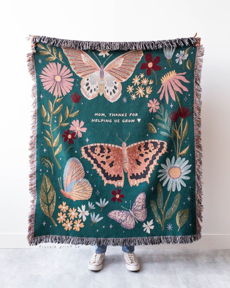 Woven blanket with butterfly and floral pattern and personalized text