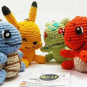May include: Four crocheted Pokemon characters: Squirtle, Pikachu, Bulbasaur, and Charmander. The characters are all smiling and have large eyes. The characters are made with different colored yarn, including blue, yellow, green, and orange.