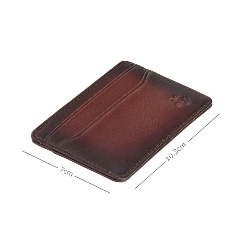 May include: A brown leather card holder with a subtle gradient effect. The card holder measures 7 inches by 10.3 inches.