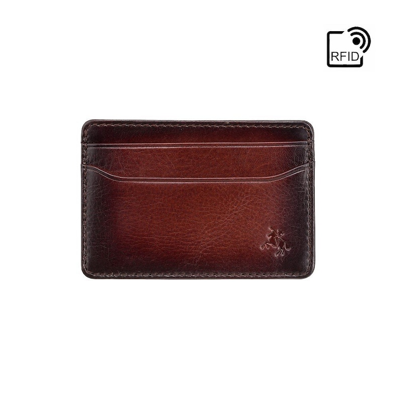 May include: A brown leather card holder with a subtle gradient effect. The card holder has a single pocket and a small logo on the front. The card holder is RFID blocking.