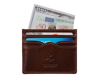 May include: A brown leather wallet with a Visconti logo. The wallet is open and has a $100 bill and a £50 bill sticking out of it. There are also two credit cards inside the wallet.