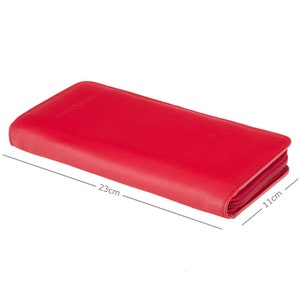 May include: A bright red leather wallet with a zipper closure. The wallet is rectangular, measuring approximately 9 inches long and 4.3 inches wide. The wallet has a textured surface and a matching red zipper.