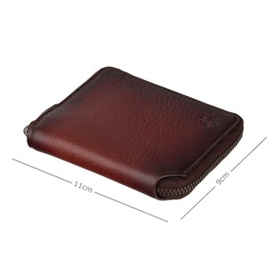 May include: A brown leather zippered wallet with a 9 inch by 11 inch measurement.