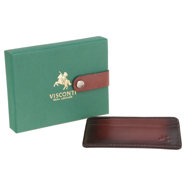 May include: A brown leather card holder with a Visconti logo and the words "Real Leather" in gold lettering. The card holder is in a green box with a brown leather strap and a silver button.