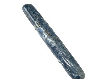 May include: A polished, elongated blue kyanite crystal wand. The crystal has a smooth, rounded end and a textured surface with streaks of silver and black. The wand is set against a white background.