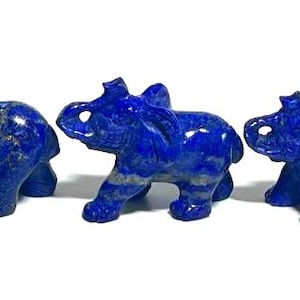 May include: A set of three ceramic mugs with a speckled, cream-colored glaze. Each mug features a different hand-painted floral design in shades of blue, green, and yellow. The mugs have a simple, rounded shape and a comfortable handle.