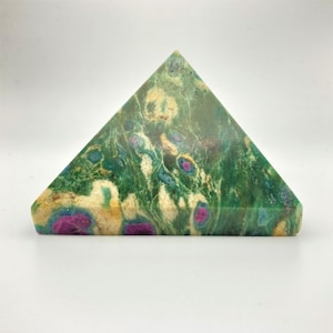 May include: A pyramid-shaped decorative stone with a flat base. The stone features a green, cream, and pink color scheme with a marbled pattern. The pyramid is a solid, geometric shape, suitable for display.