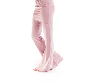 May include: A woman is wearing a mauve-colored, sleeveless top and matching wide-legged pants. The top has a scoop neck and the pants have a wide leg.