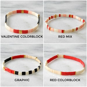 May include: Four different styles of tile bracelets, each with a unique color combination. The bracelets are made with red, white, black, and pink tiles. The bracelets are called "Valentine Colorblock", "Red Mix", "Graphic", and "Red Colorblock".