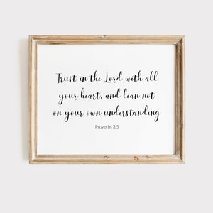 May include: A framed print with a white background and black text. The text reads "Trust in the Lord with all your heart, and lean not on your own understanding. Proverbs 3:5".