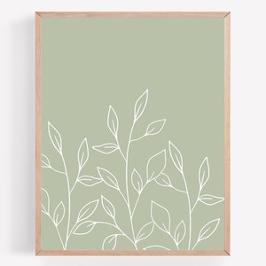 May include: A framed print with a minimalist design featuring white line drawings of leaves on a sage green background.