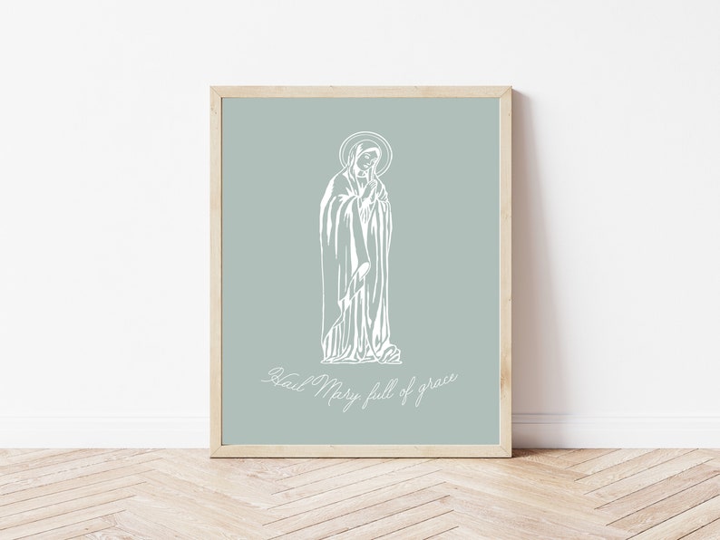 May include: A white line drawing of the Virgin Mary on a light blue background. The text "Hail Mary, full of grace" is written below the image.