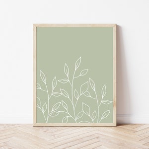 May include: A framed print with a minimalist design featuring white line drawings of leaves on a sage green background.