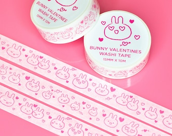 May include: Three rolls of pink and white washi tape with a bunny rabbit and heart design. The tape reads "Bunny Valentines Washi Tape 15mm x 10m".