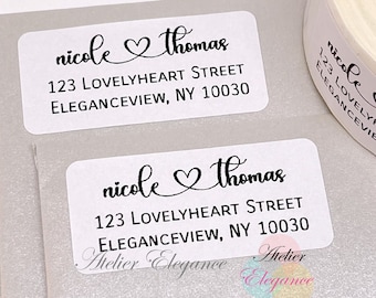 May include: White rectangular return address labels with black text. The text reads "nicole thomas" with a heart symbol between the names. The address is "123 LOVELYHEART STREET ELEGANCEVIEW, NY 10030".