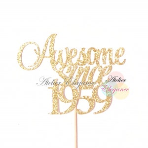 May include: Gold glitter cake topper with the text "Awesome since 1959" and the words "Atelier Elegance" on the bottom.