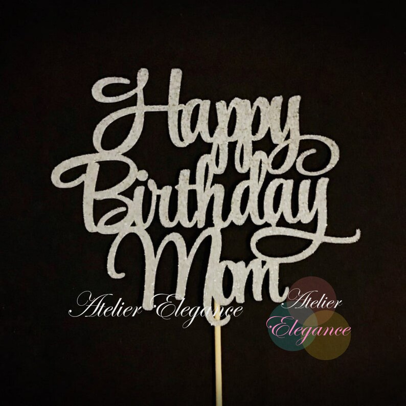 May include: Silver glitter cake topper with the text "Happy Birthday Mom".