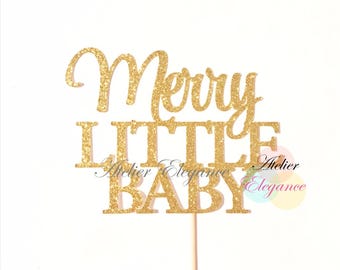 May include: Gold glitter cake topper with the words "Merry Little Baby".