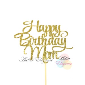 May include: Gold glitter cake topper with the text "Happy Birthday Mom" in a cursive font.