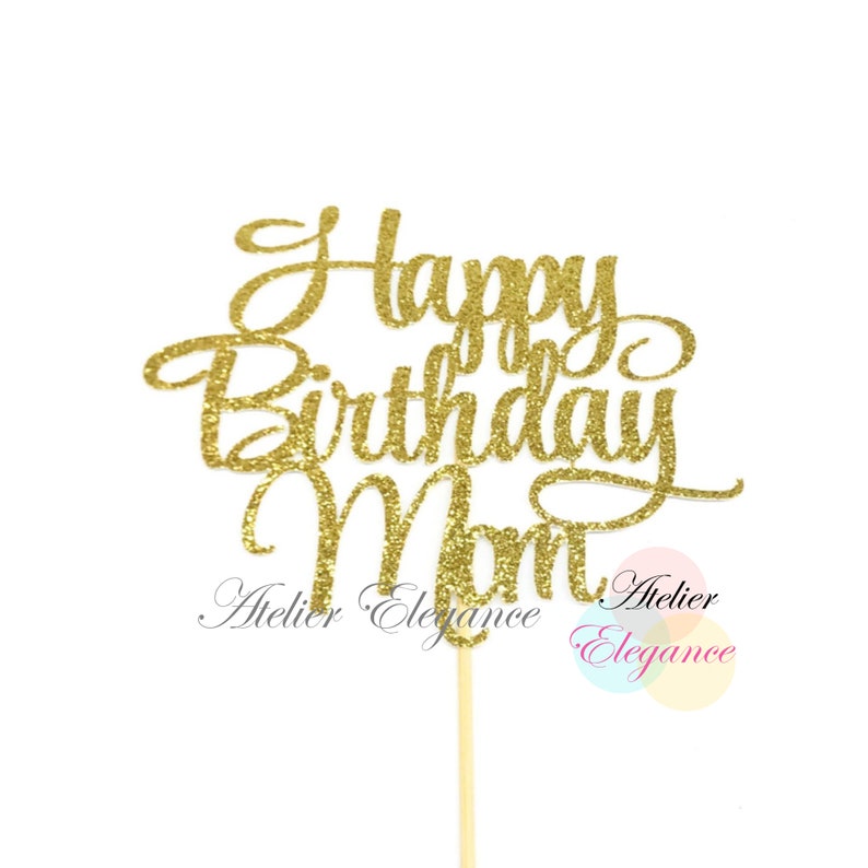 May include: Gold glitter cake topper with the text "Happy Birthday Mom" in a cursive font.