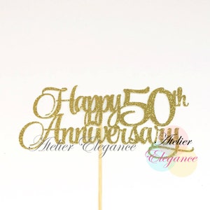 May include: Gold glitter cake topper that says "Happy 50th Anniversary".