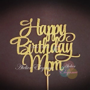 May include: Gold glitter cake topper with the words "Happy Birthday Mom".