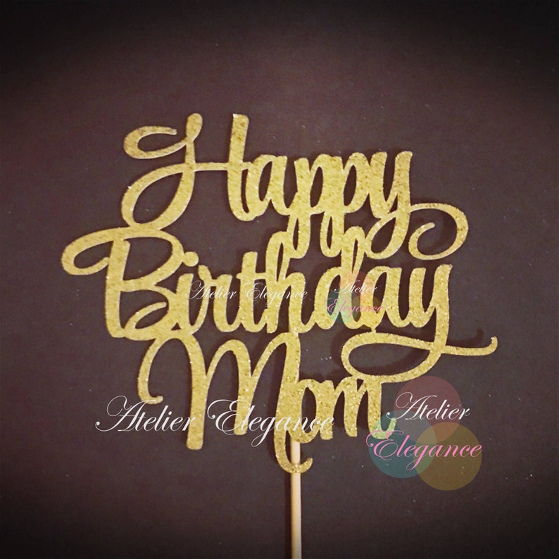 May include: Gold glitter cake topper with the words "Happy Birthday Mom".