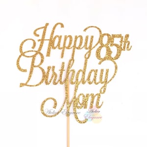 May include: Gold glitter cake topper that says "Happy 85th Birthday Mom".