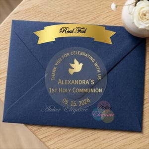 May include: A navy blue envelope with a gold foil banner that reads "Real Foil." A clear sticker with gold text and a dove graphic is centered on the envelope. The sticker says "Alexandra's 1st Holy Communion" and the date "05.15.2026."