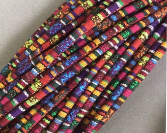 May include: A bundle of colorful striped cords, featuring a variety of bright colors, including red, orange, yellow, green, blue, purple, and white.