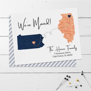 May include: A white card with the text "We've Moved!" and a blue and pink map of Pennsylvania and Illinois with hearts on each state. The text "The Harris Family" is below the map with the address "7 Swanson Drive, Oak Forest, IL 60452".