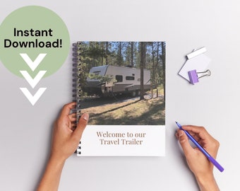 May include: A spiral bound notebook with a photo of a travel trailer parked in a wooded area. The cover text reads "Welcome to our Travel Trailer".