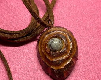 Hand carved avocado wood sculpture swirls and twirls with Stone. handmade yep hand carved unique and original only one. A lovely Pendant4u