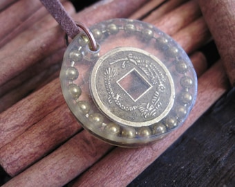 Chinese coin immersed in resin with bronze