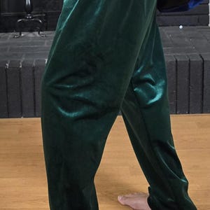 Puede incluir: Un pantal&oacute;n de terciopelo verde oscuro con cintura de cord&oacute;n.