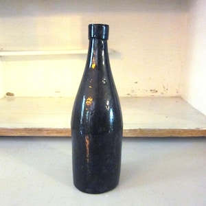 Vintage brown blown glass bottle round bottle  medicinal or beer bottle?