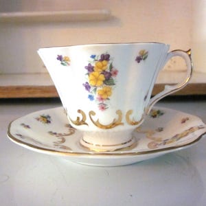 Queen Anne bone china teacup and saucer purple and yellow violets gold detail