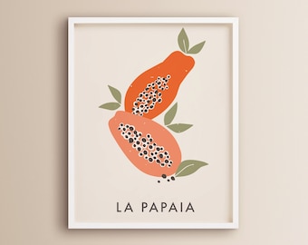 Op de afbeelding: Een wit ingelijst print met een minimalistische illustratie van twee papajahelften met zwarte zaden. De tekst "LA PAPAIA" is onder de illustratie gedrukt.