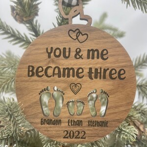 You and me became three. custom new baby ornament 2024. first baby ornament. First baby ornament. Family ornament. new mom and dad ornament. image 4