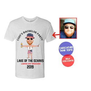 May include: A gray t-shirt with a cartoon illustration of a man wearing a red, white, and blue hat and holding a beer. The text on the shirt reads "Cody's Bachelor Party", "Lake of the Ozarks", "Labor Day Weekend", and "2019".