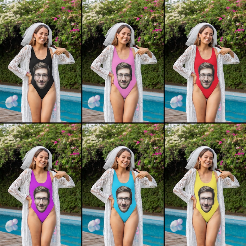 May include: Six women wearing white bridal veils and different coloured one-piece swimsuits with a man's face printed on the front. The swimsuits are pink, red, blue, yellow, and two shades of blue. The women are standing in front of a swimming pool.