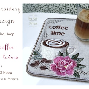 May include: Embroidered design for a coffee coaster featuring a cup of coffee with a swirl of foam, a pink flower, and coffee beans. The design is on a beige linen-like fabric and reads "coffee time".